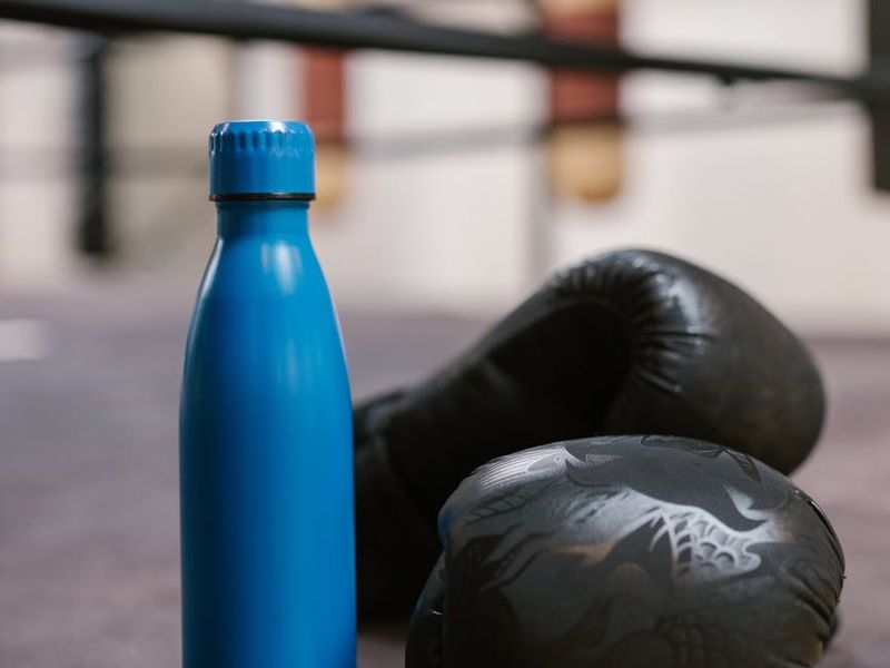 Close up of sports equipment and water bottle in gym