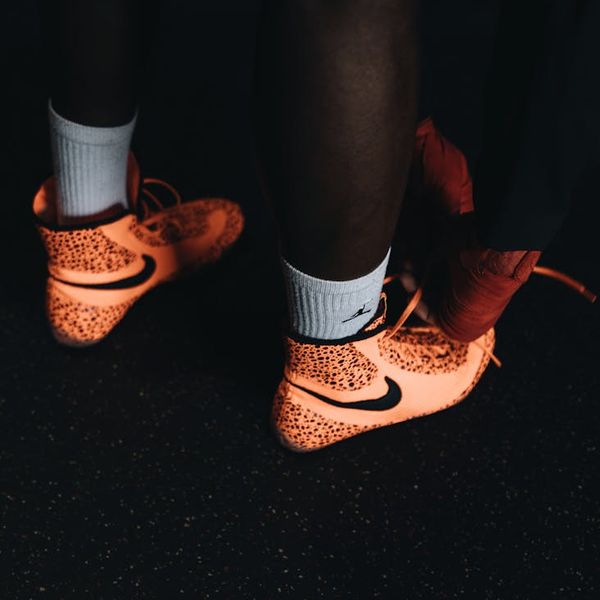 Close up of sports sneakers on a dark floor