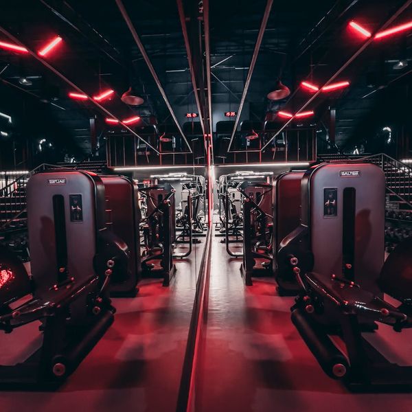 Minimalist training space with neon rose lighting